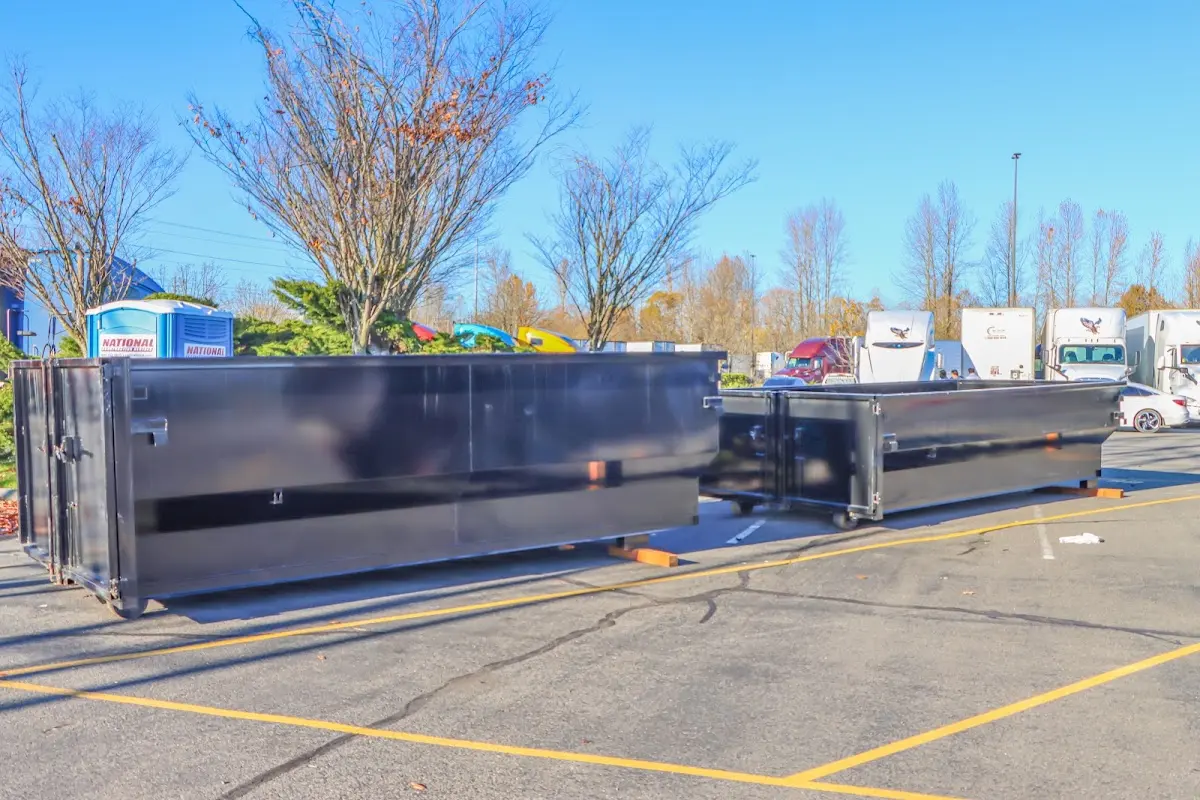 Professional dumpster rental service with roll-off container on residential driveway in Truth or Consequences